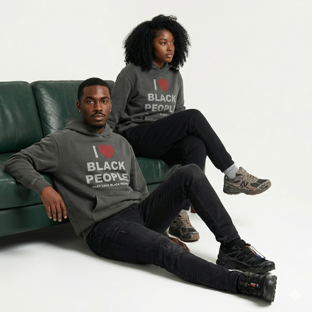 Two Black people wearing gray hoodie with the message 'I Love Black People That Love Black People' sitting on a green couch.