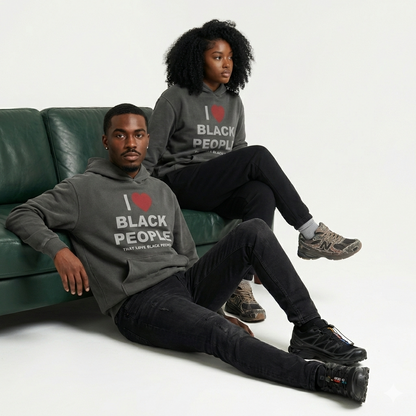 Two Black people wearing gray hoodie with the message 'I Love Black People That Love Black People' sitting on a green couch.